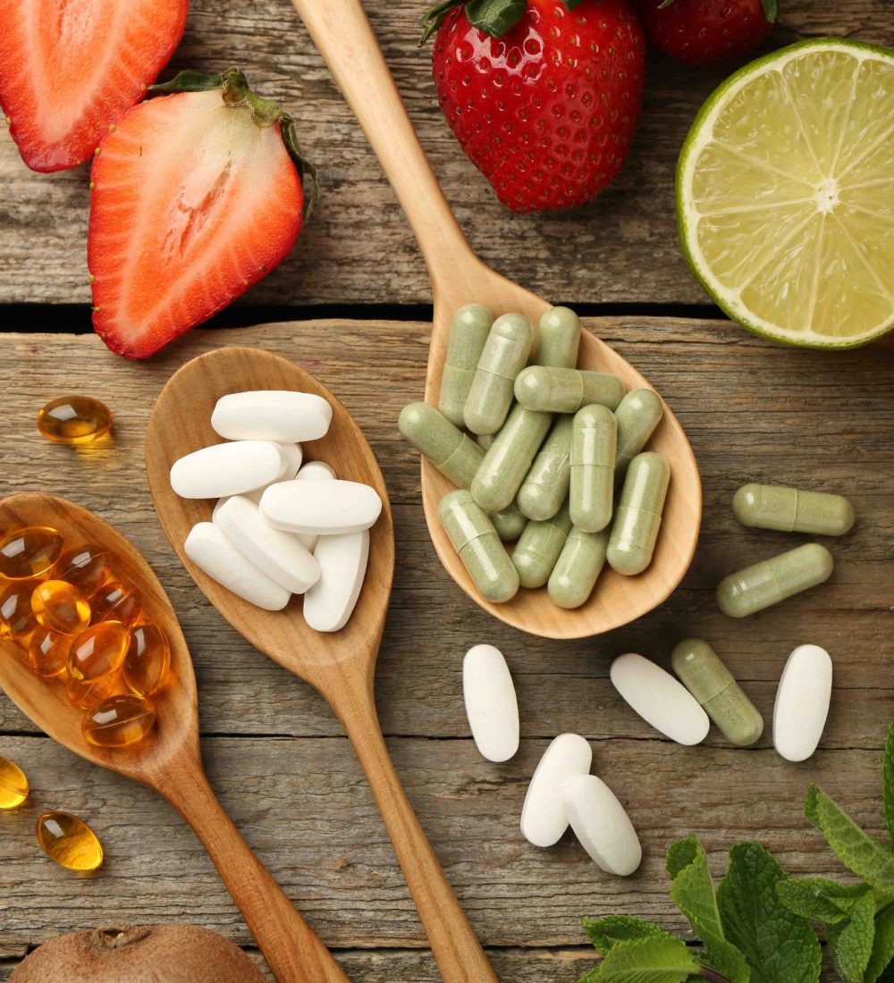 different-vitamin-pills-fresh-fruits-old-wooden-table-flat-lay (1)